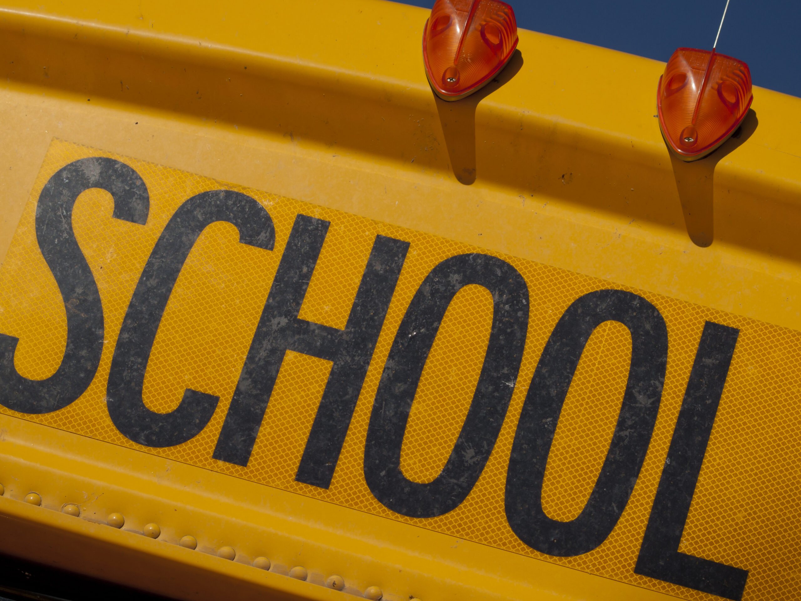 Close-up of a yellow school bus with the word "SCHOOL" in large black letters, capturing the essence of how to start a nonprofit dedicated to education.